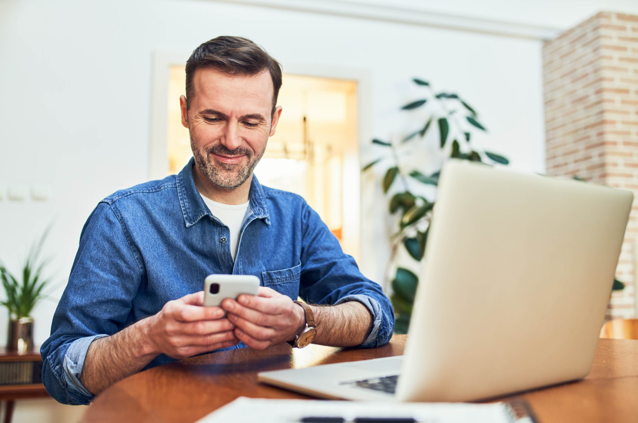 Mozaique SME Law Firm Client Portal - Man using mobile phone to check the progress of his legal matter - Feature